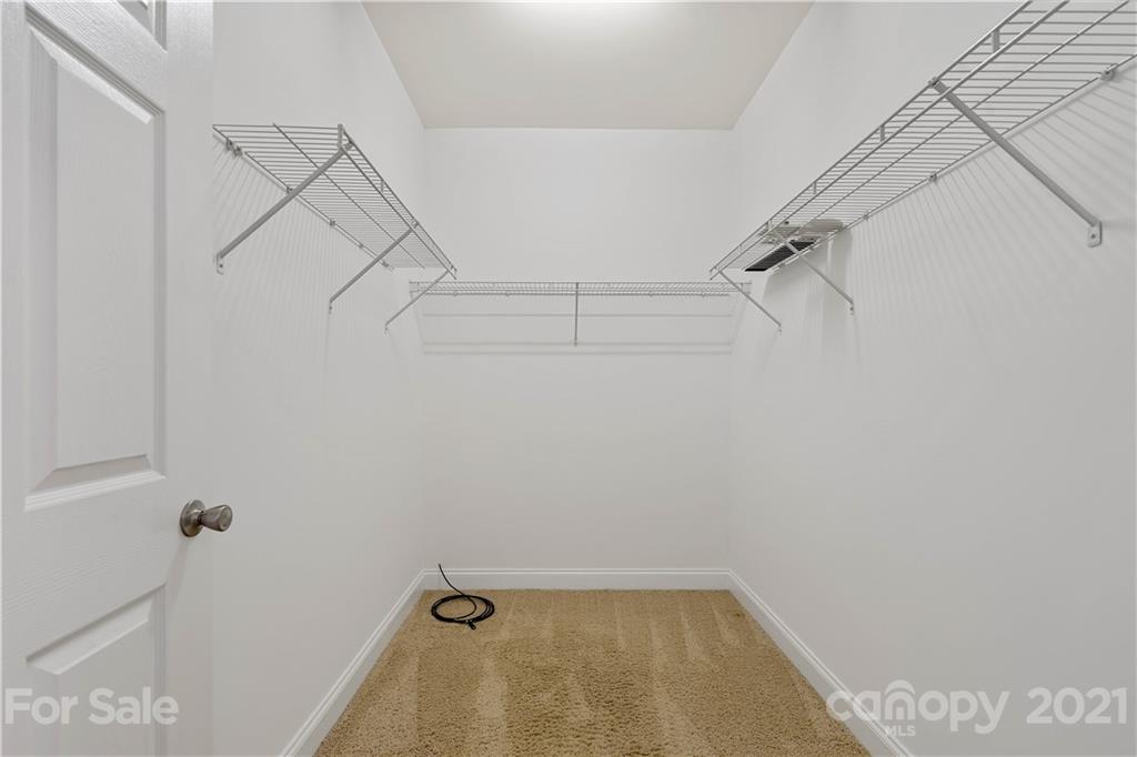 8929 Rosalyn Glen Road, Unit 108 Cornelius, NC 28031 - Photo 22 of 28 a view of a room with racks on the wall