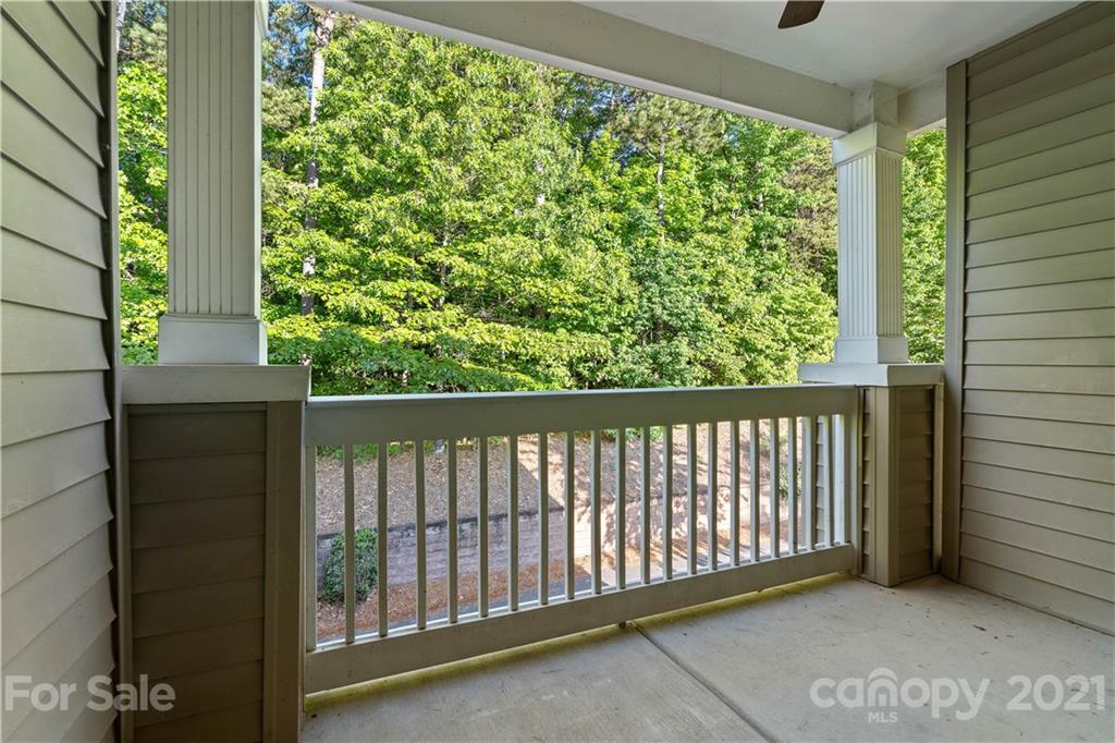 8929 Rosalyn Glen Road, Unit 108 Cornelius, NC 28031 - Photo 24 of 28 a balcony with trees in front of it