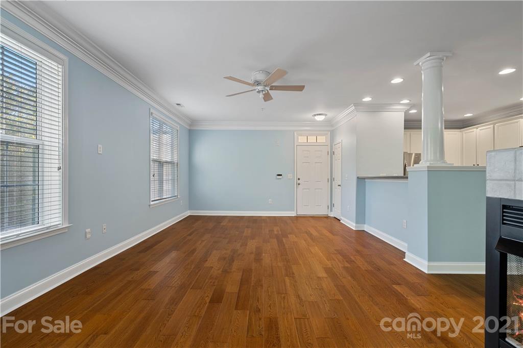 8929 Rosalyn Glen Road, Unit 108 Cornelius, NC 28031 - Photo 4 of 28 a view of an empty room with wooden floor and a window