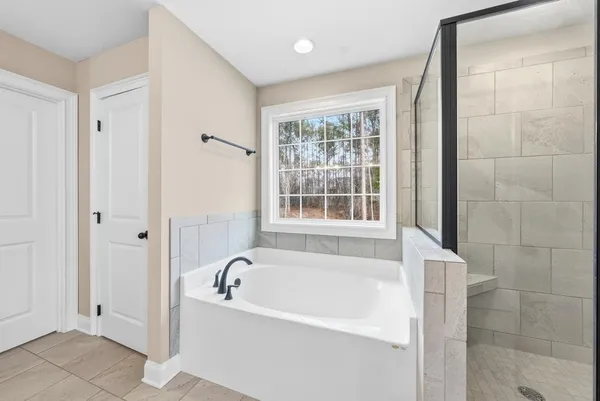 a white bath tub sitting next to a window