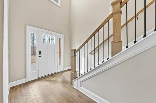 a view of an entryway with wooden floor