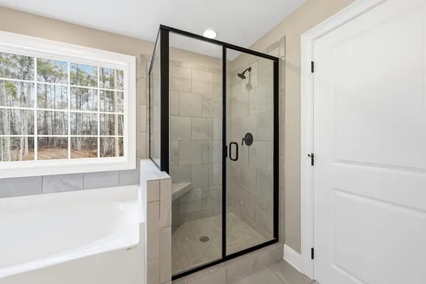 a bathroom with a shower and a tub