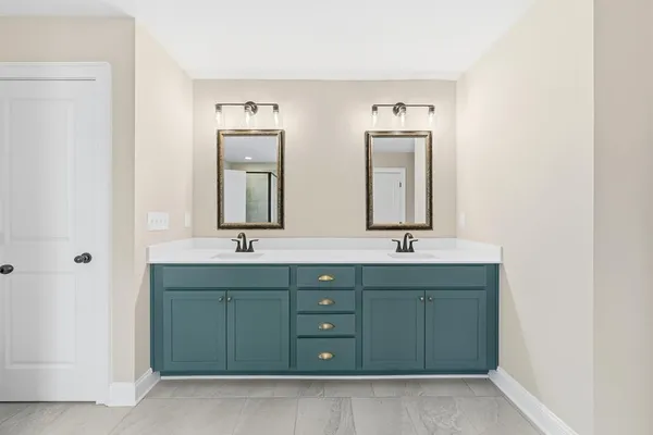 a bathroom with a double vanity sink and mirror