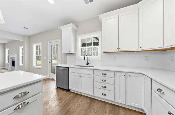 a kitchen with cabinets appliances a sink and a window