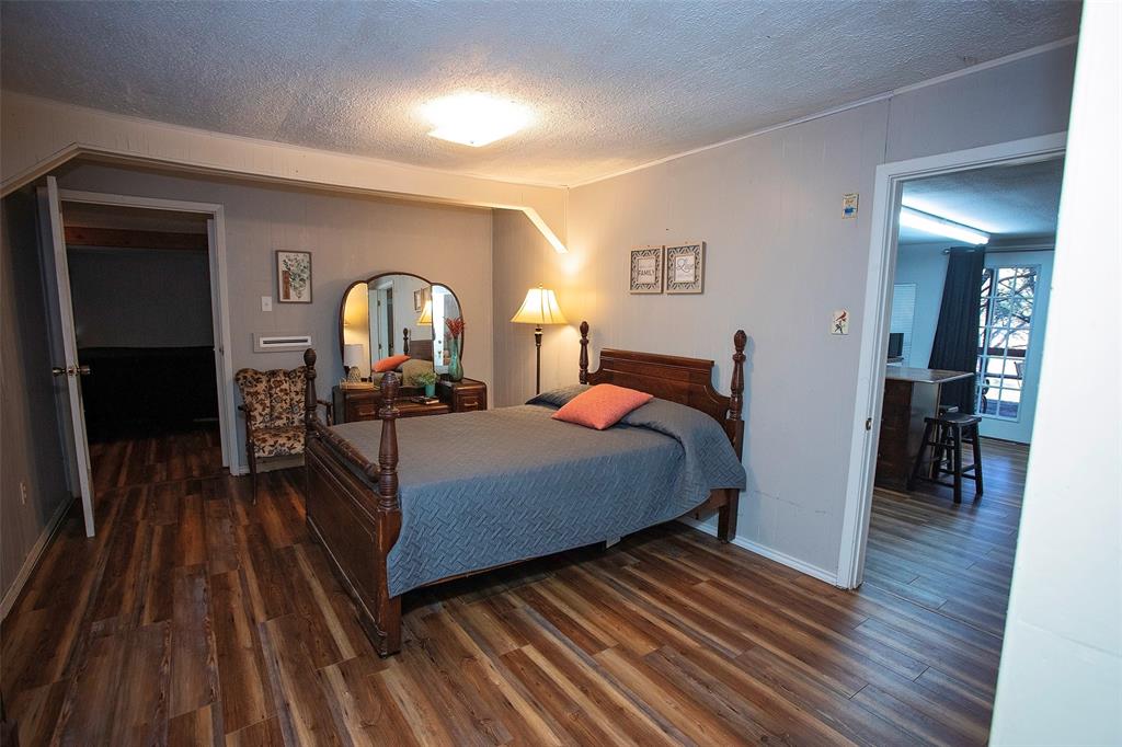 9051 Lacy Road Graford, TX 76449 - Photo 12 of 23 Middle bedroom that opens to the kitchen.