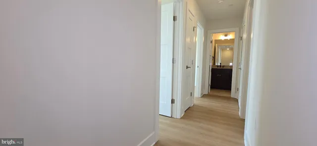 a view of a hallway with wooden floor