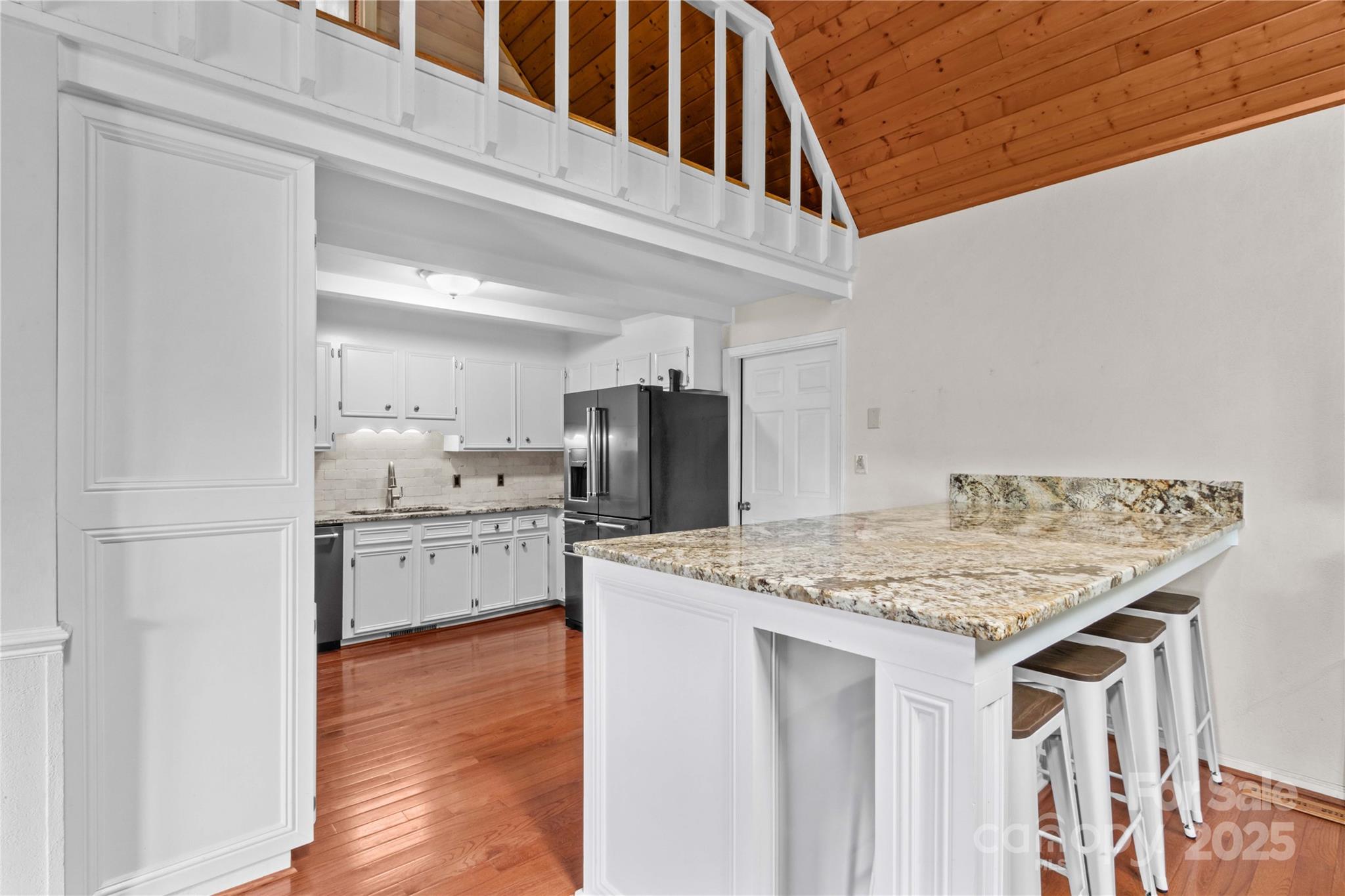 296 Hicks Creek Road Troutman, NC 28166 - Photo 13 of 48 a kitchen with stainless steel appliances kitchen island a table and chairs