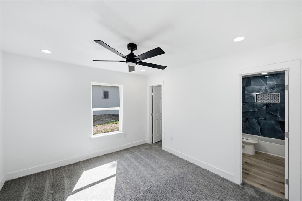 1909 Burchill Road Fort Worth, TX 76105 - Photo 10 of 18 White-walled room featuring a black ceiling fan, recessed lighting, and gray carpeting