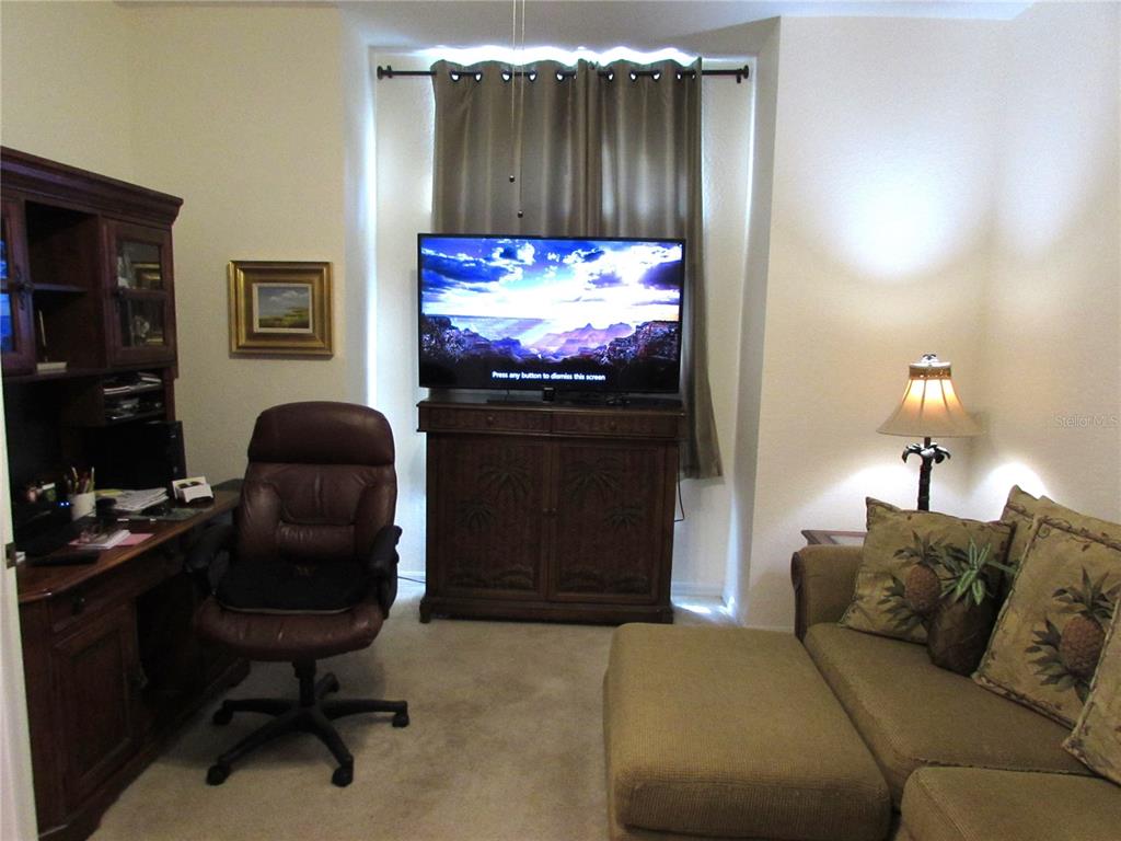 19367 Southwest 101st Place Road Dunnellon, FL 34432 - Photo 18 of 38 a living room with furniture and a flat screen tv