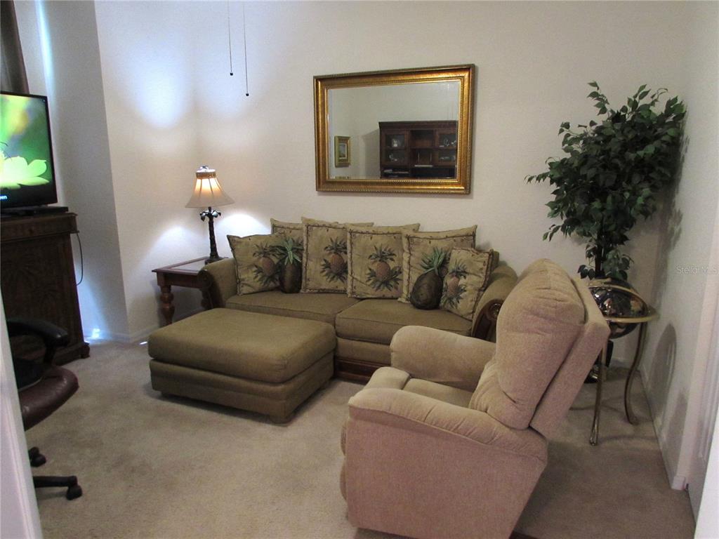 19367 Southwest 101st Place Road Dunnellon, FL 34432 - Photo 19 of 38 a living room with furniture and a flat screen tv