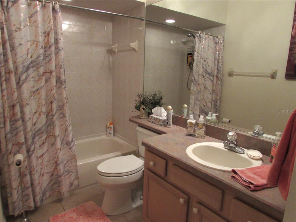 19367 Southwest 101st Place Road Dunnellon, FL 34432 - Photo 21 of 38 a bathroom with a granite countertop sink toilet and shower