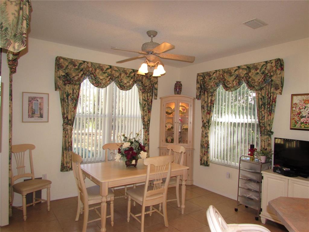 19367 Southwest 101st Place Road Dunnellon, FL 34432 - Photo 10 of 38 a dining room with furniture a chandelier and window