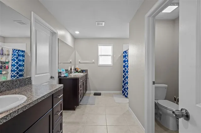 a spacious bathroom with a sink and a mirror
