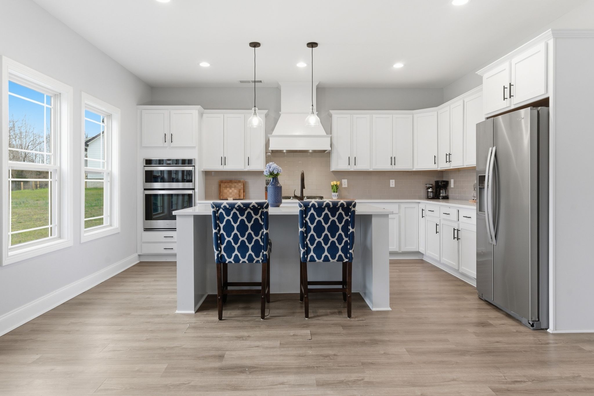 1166 Carney Winters Road Ashland City, TN 37015 - Photo 11 of 41 a open kitchen with stainless steel appliances granite countertop a stove a refrigerator a oven a white table and chairs
