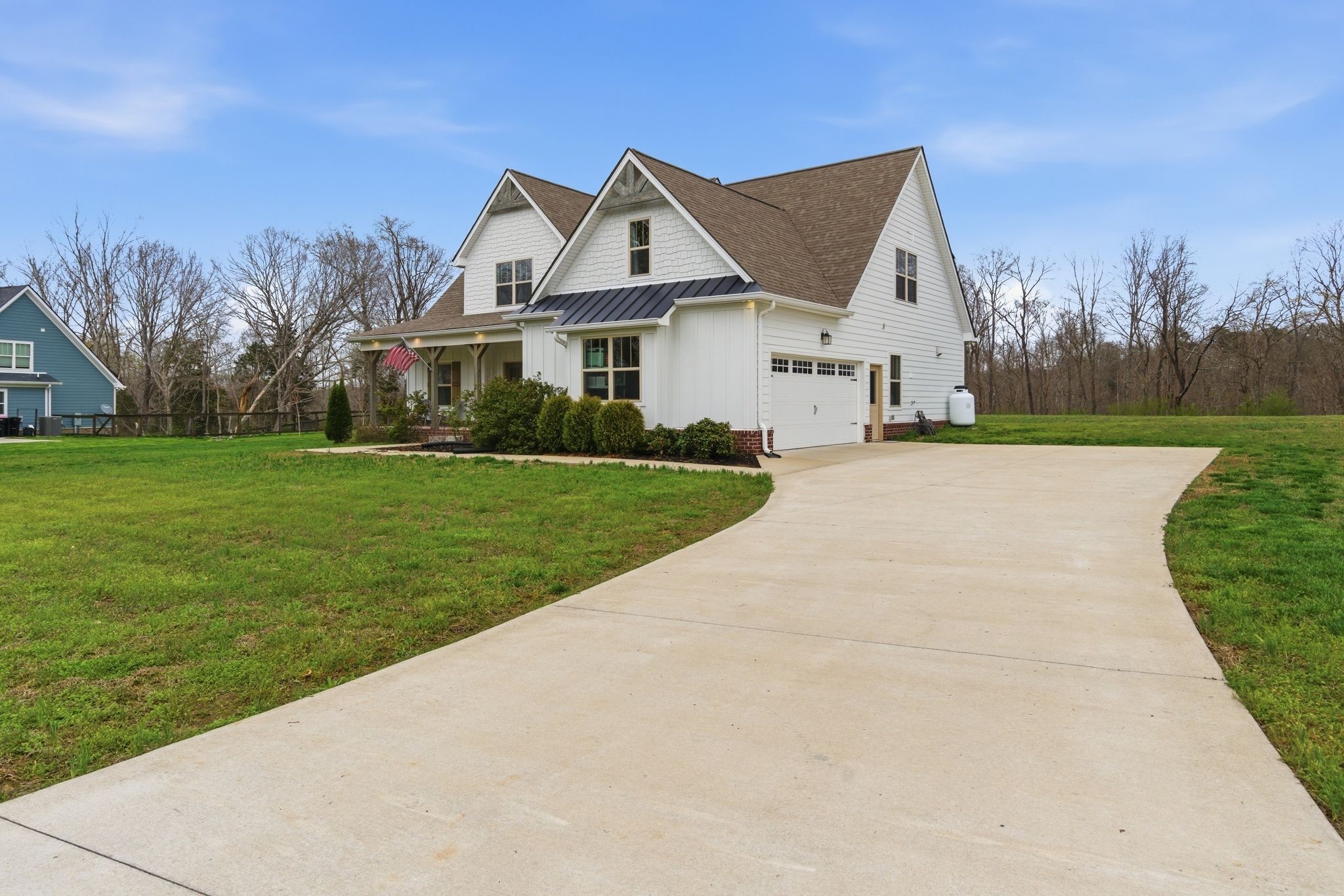 1166 Carney Winters Road Ashland City, TN 37015 - Photo 3 of 41 a view of a white house next to a yard with big trees