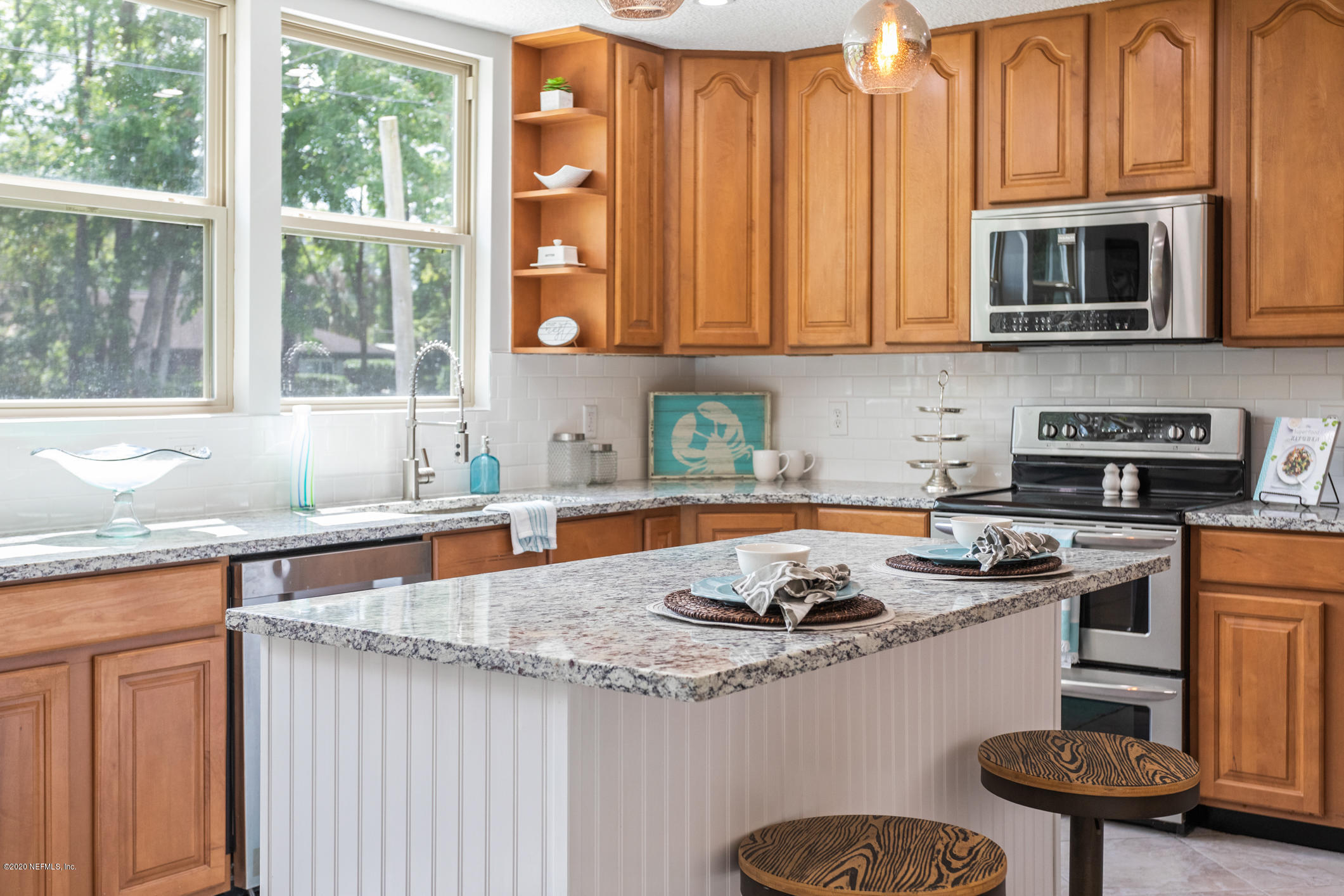 1427 Satsuma Road St. Johns, FL 32259 - Photo 23 of 59 a kitchen with stainless steel appliances granite countertop a sink a stove and a microwave