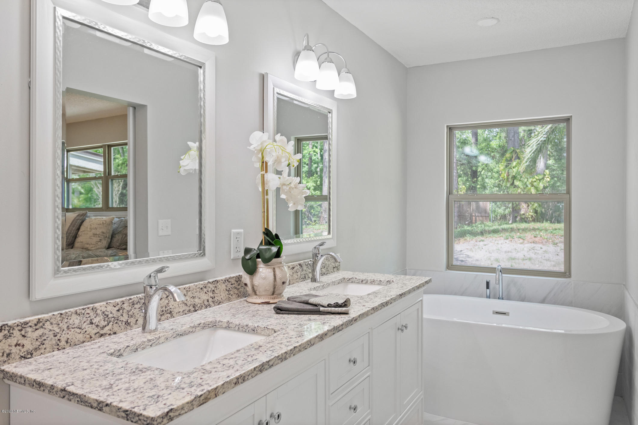 1427 Satsuma Road St. Johns, FL 32259 - Photo 31 of 59 a bathroom with a granite countertop sink and a mirror
