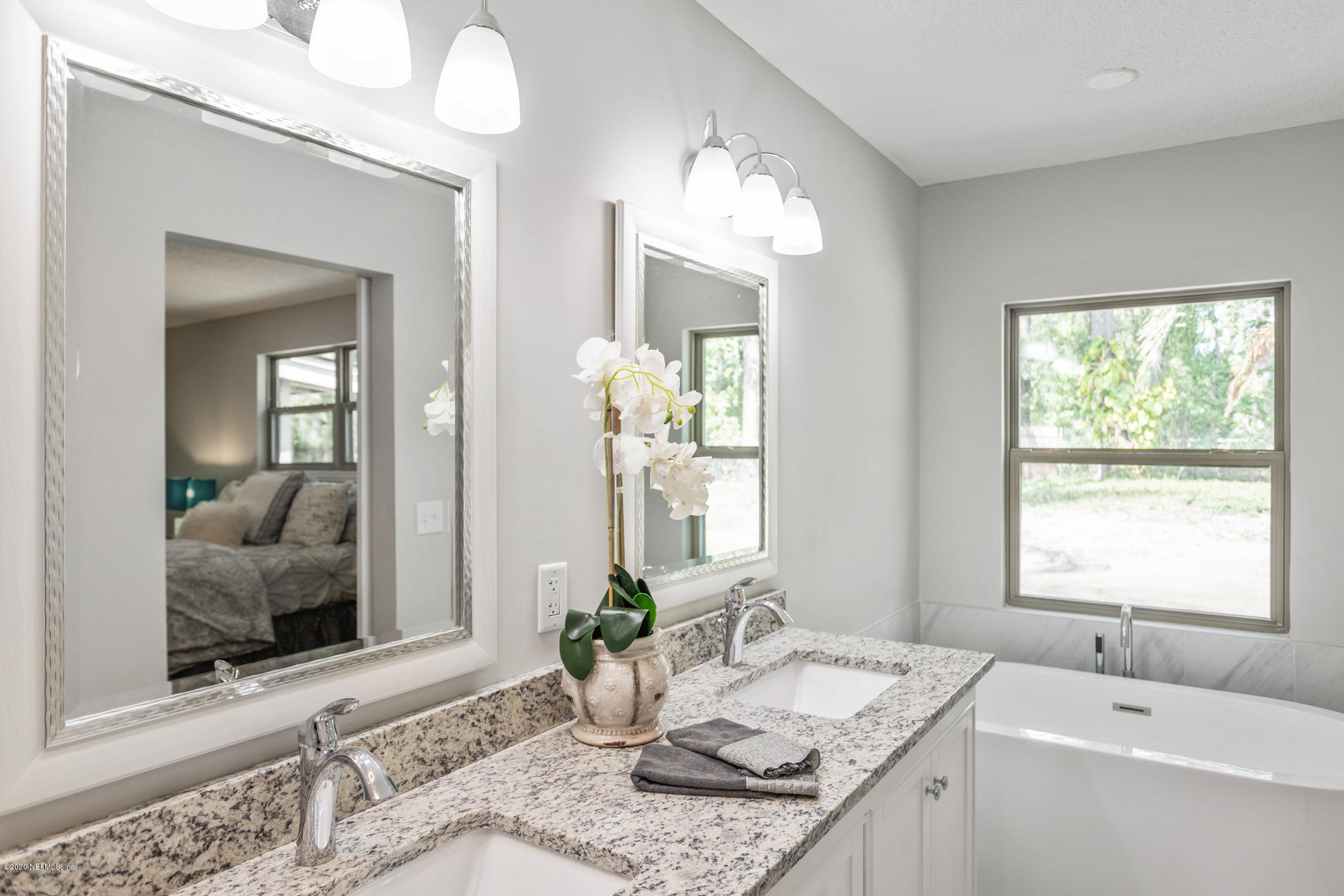 1427 Satsuma Road St. Johns, FL 32259 - Photo 35 of 59 a bath room with a granite countertop sink and a mirror