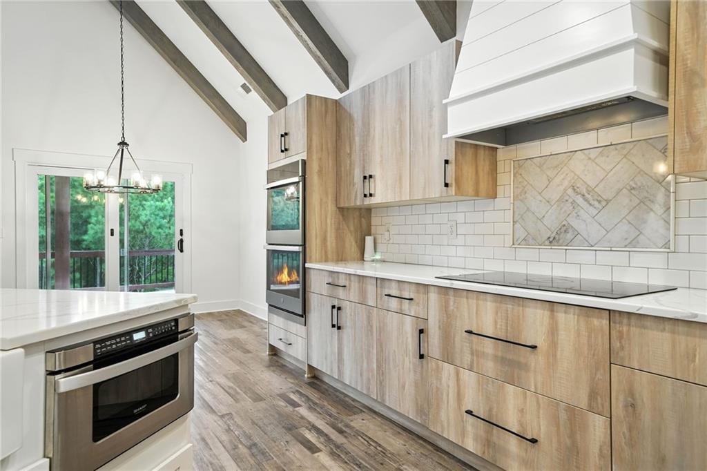 548 Stoneledge Road Jasper, GA 30143 - Photo 12 of 46 a kitchen with granite countertop a sink stove and cabinets