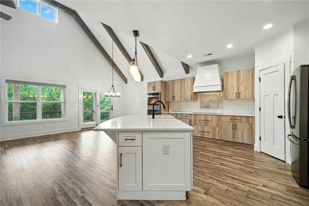 548 Stoneledge Road Jasper, GA 30143 - Photo 13 of 46 a kitchen with stainless steel appliances granite countertop a sink a stove and a wooden floors