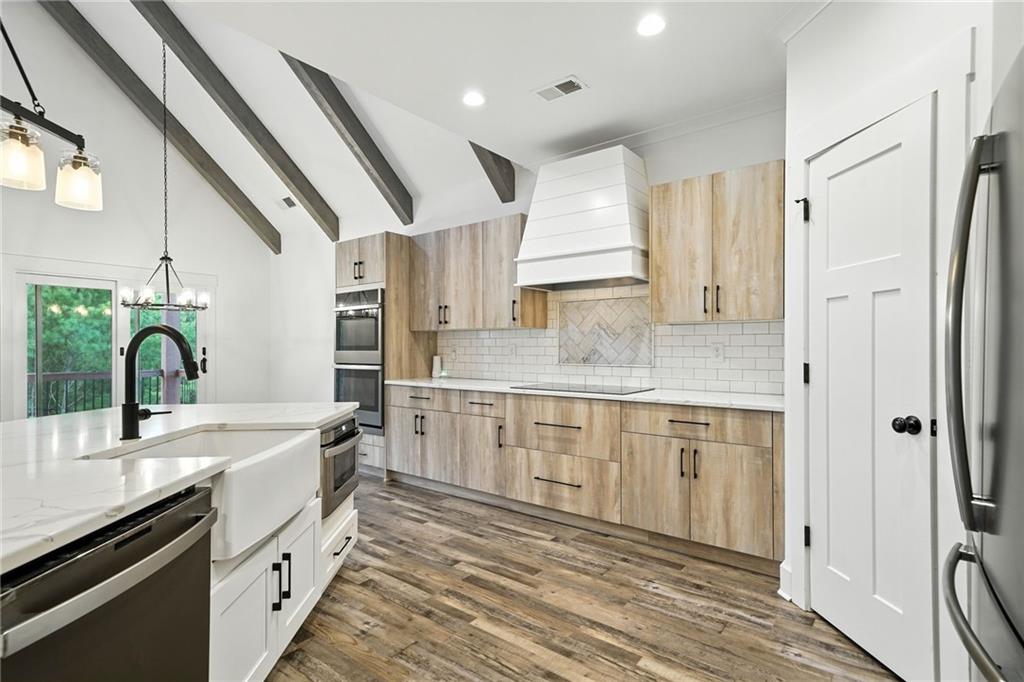 548 Stoneledge Road Jasper, GA 30143 - Photo 14 of 46 a kitchen with a sink cabinets stainless steel appliances and a window