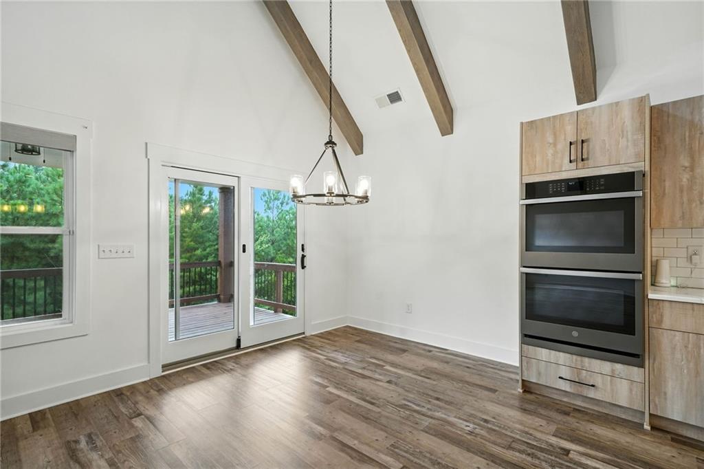 548 Stoneledge Road Jasper, GA 30143 - Photo 16 of 46 a view of empty room with wooden floor and fan