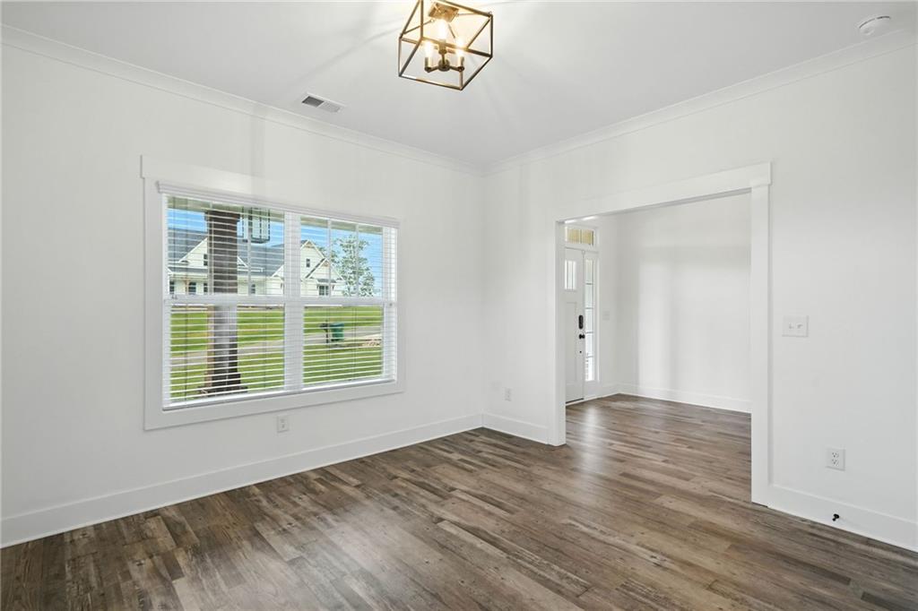 548 Stoneledge Road Jasper, GA 30143 - Photo 23 of 46 a view of an empty room with a window and wooden floor