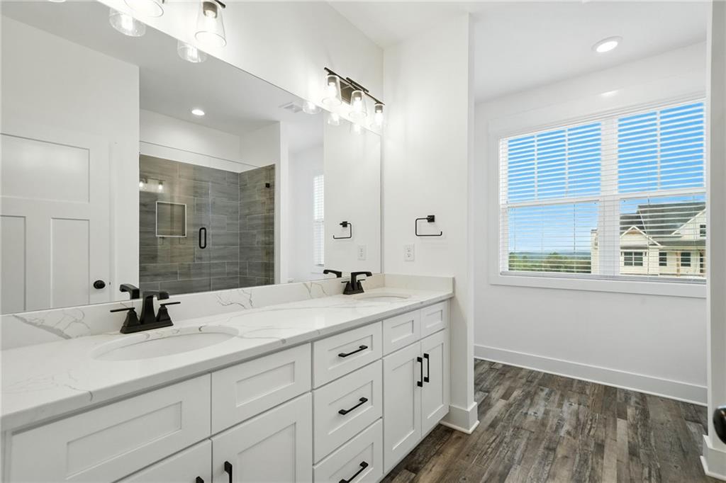 548 Stoneledge Road Jasper, GA 30143 - Photo 35 of 46 a bathroom with double vanity sink a mirror a window and vanity