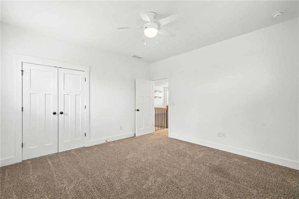 548 Stoneledge Road Jasper, GA 30143 - Photo 39 of 46 an empty room with a ceiling fan and a window