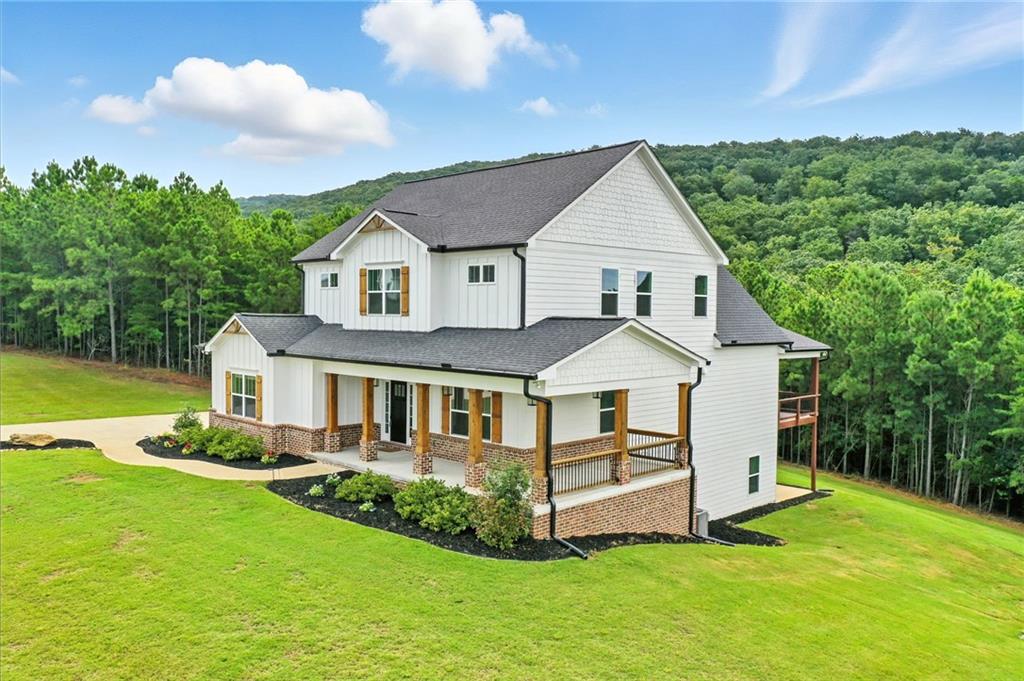 548 Stoneledge Road Jasper, GA 30143 - Photo 42 of 46 a front view of a house with a yard potted plants and a large tree