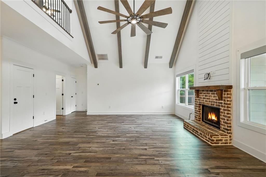 548 Stoneledge Road Jasper, GA 30143 - Photo 10 of 46 a view of an empty room with wooden floor fireplace and a window