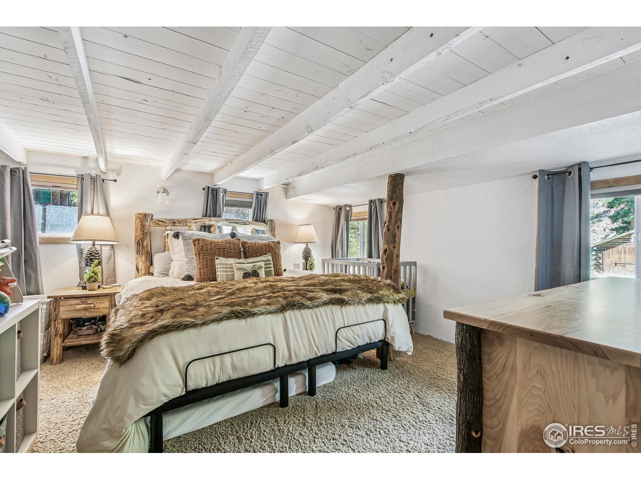 541 Riverside Drive Lyons, CO 80540 - Photo 11 of 45 a bed room with a bed window and a table