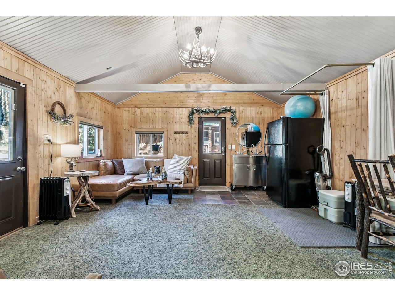 541 Riverside Drive Lyons, CO 80540 - Photo 24 of 45 a living room with furniture and a chandelier