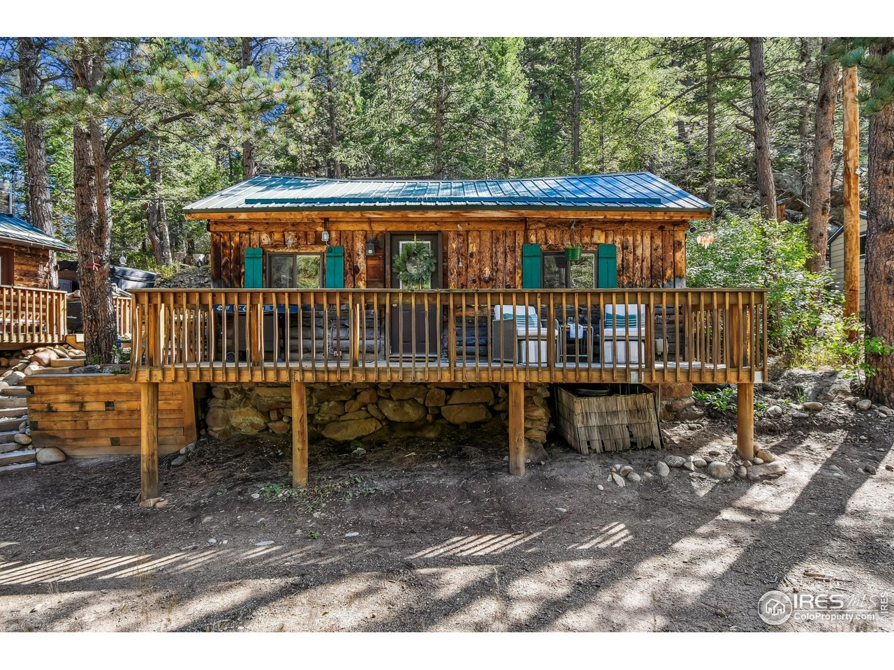 541 Riverside Drive Lyons, CO 80540 - Photo 29 of 45 a view of a house with a wooden deck and furniture