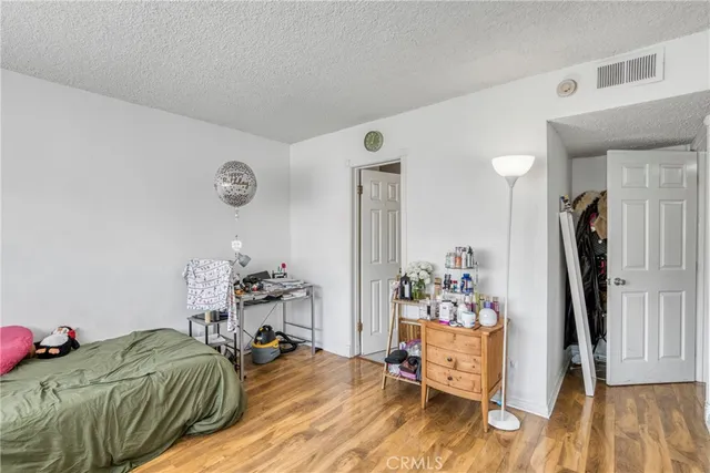 a bedroom with furniture and a wooden floor