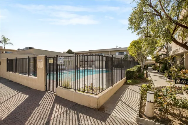a view of a balcony with wooden floor and fence