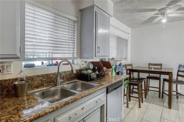 a kitchen with a sink cabinets and window