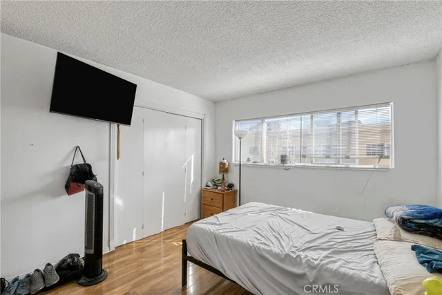 a bed room with a bed and a television