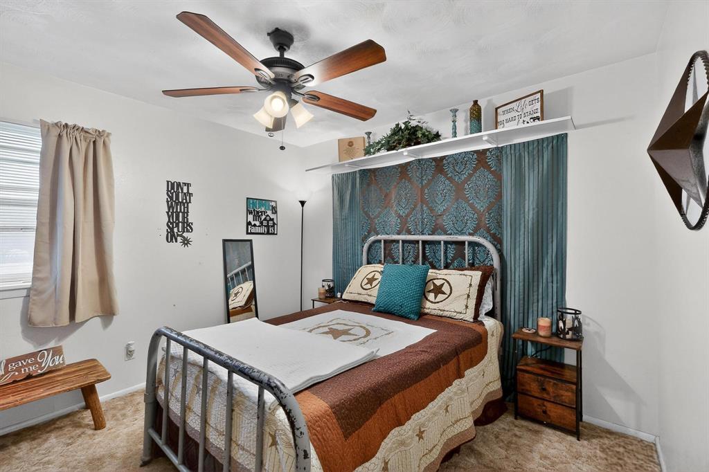 202 Senter Valley Road Irving, TX 75060 - Photo 23 of 32 Bedroom featuring a ceiling fan with integrated lighting, window with blinds, and carpeted flooring