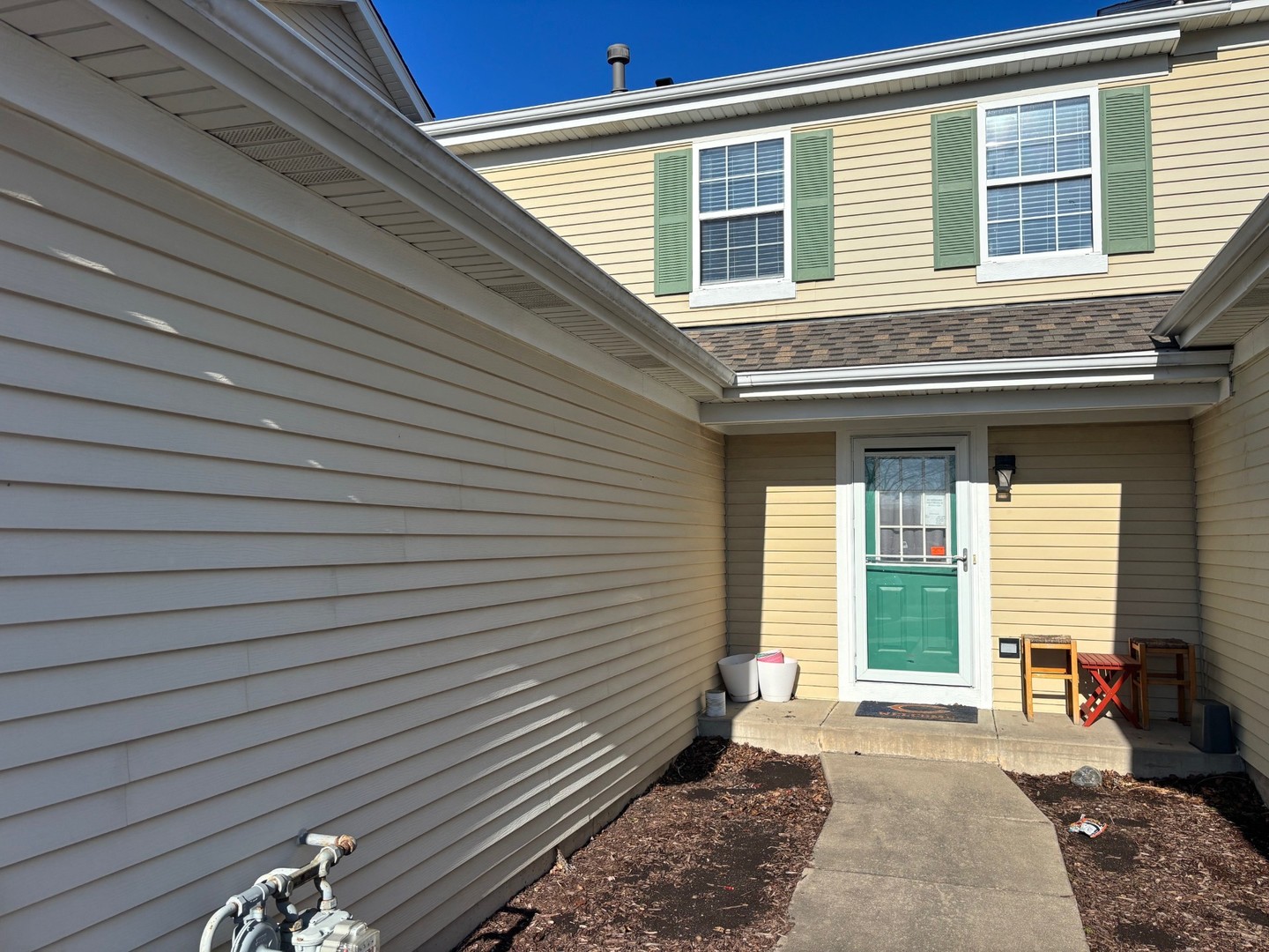 655 Chestnut Ridge Minooka, IL 60447 - Photo 3 of 21 a view of a house with a brick wall and a large window