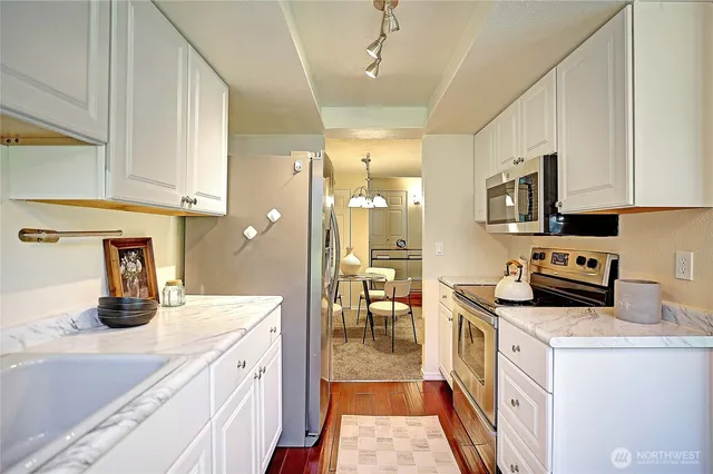 a kitchen with sink a stove and cabinets