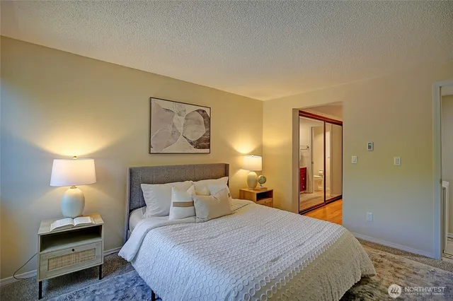 a bedroom with a bed and a lamp