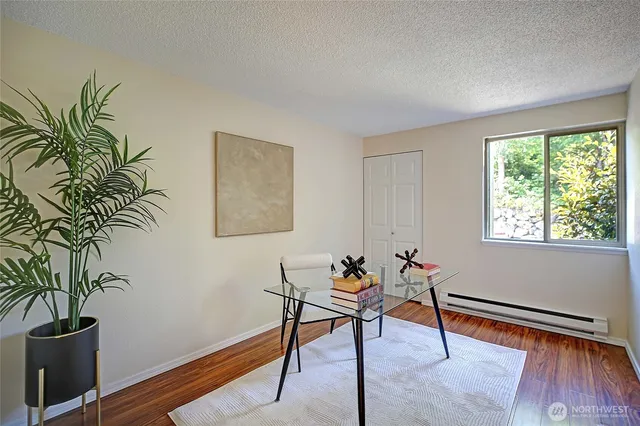 a living room with furniture and a potted plant