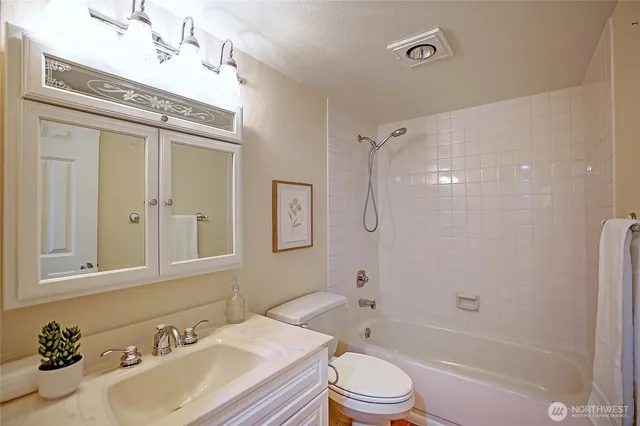 a bathroom with a sink toilet tub and shower