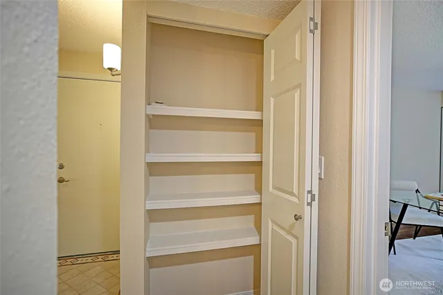 a view of walk in closet with empty room