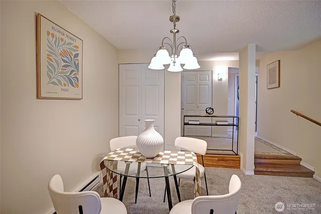 a view of a dining room with furniture and chandelier