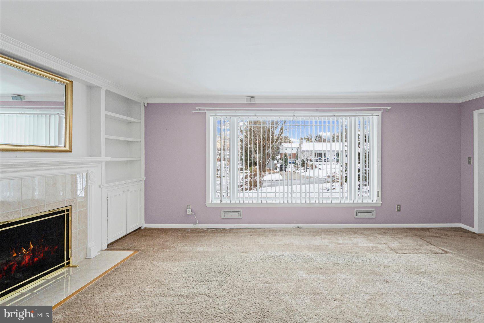 1004 Dunblane Road Baltimore, MD 21286 - Photo 9 of 60 a view of an empty room with a fireplace and a window