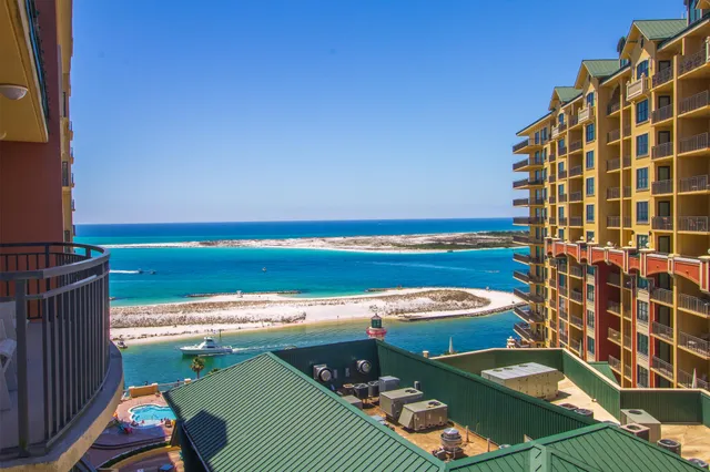 a bedroom with a bed tv and a chandelier