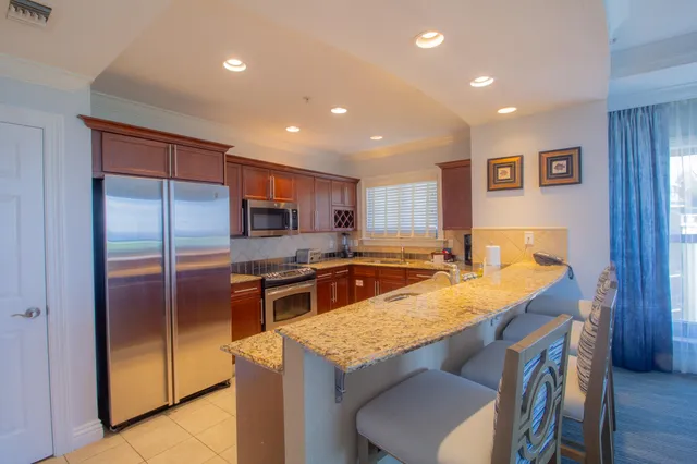 a view of a chairs and table in the balcony