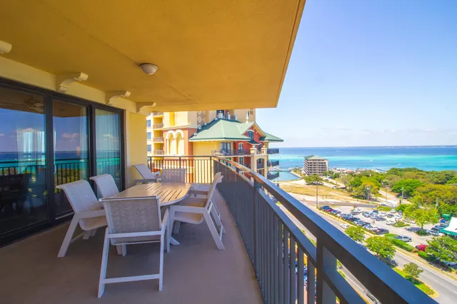 a view of a balcony with wooden floor and fence